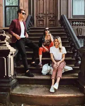 Three friend sitting on staircase outside of house in Bedford-Stuyvesant, Brooklyn, New York City